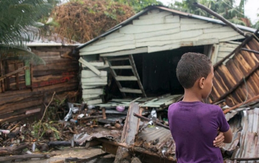 boy standing at collapsed home after hurricane irma hit