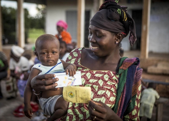 A female health worker helps feed a malnourished child special formula F70 at Children's Nutrition Ward in Malawi.