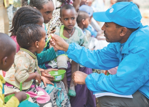 A health specialist at UNICEF Ethiopia Tigray office feeds Bertukan a nutritious porridge.