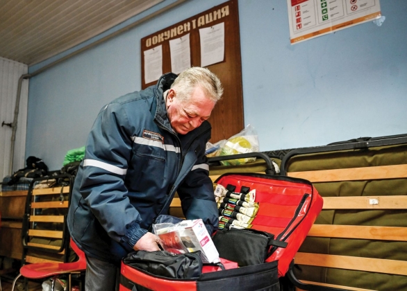 A first responder looks inside a case of emergency supplies.