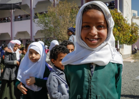 A young girl smiles amongst students at Al-Nasr secondary school in Sana'a Governorate, Yemen.